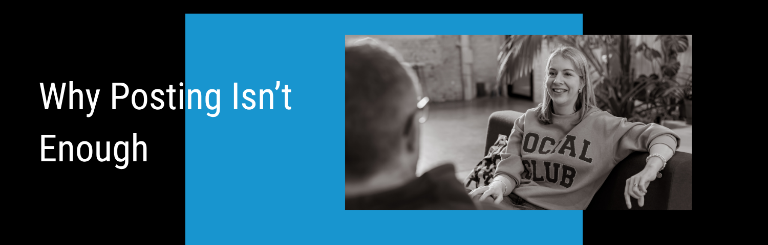 Blog Banner of the blog "Social Media Strategy for Small Business: Why Posting Isn’t Enough". There's a photo of Lindsay on a sofa talking to Andy, on top of a blue square on top of a black background.